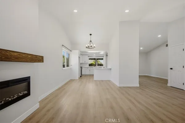 a view of a kitchen with wooden floor and a kitchen