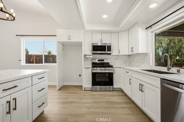 a kitchen with stainless steel appliances a stove sink and microwave