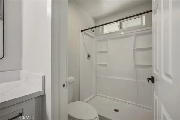 a bathroom with a shower and a toilet