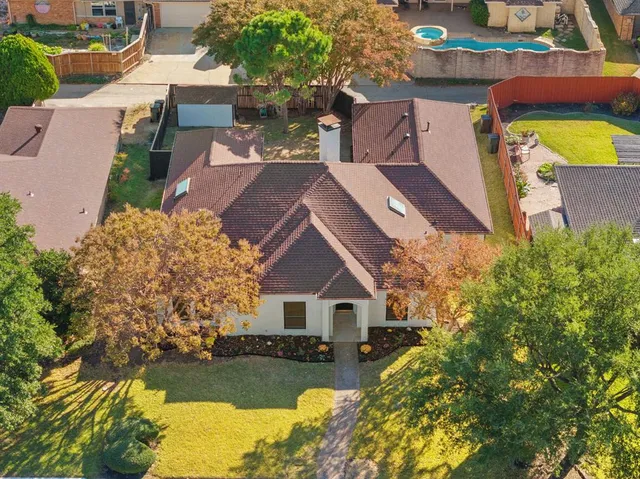 an aerial view of a house with a lake view