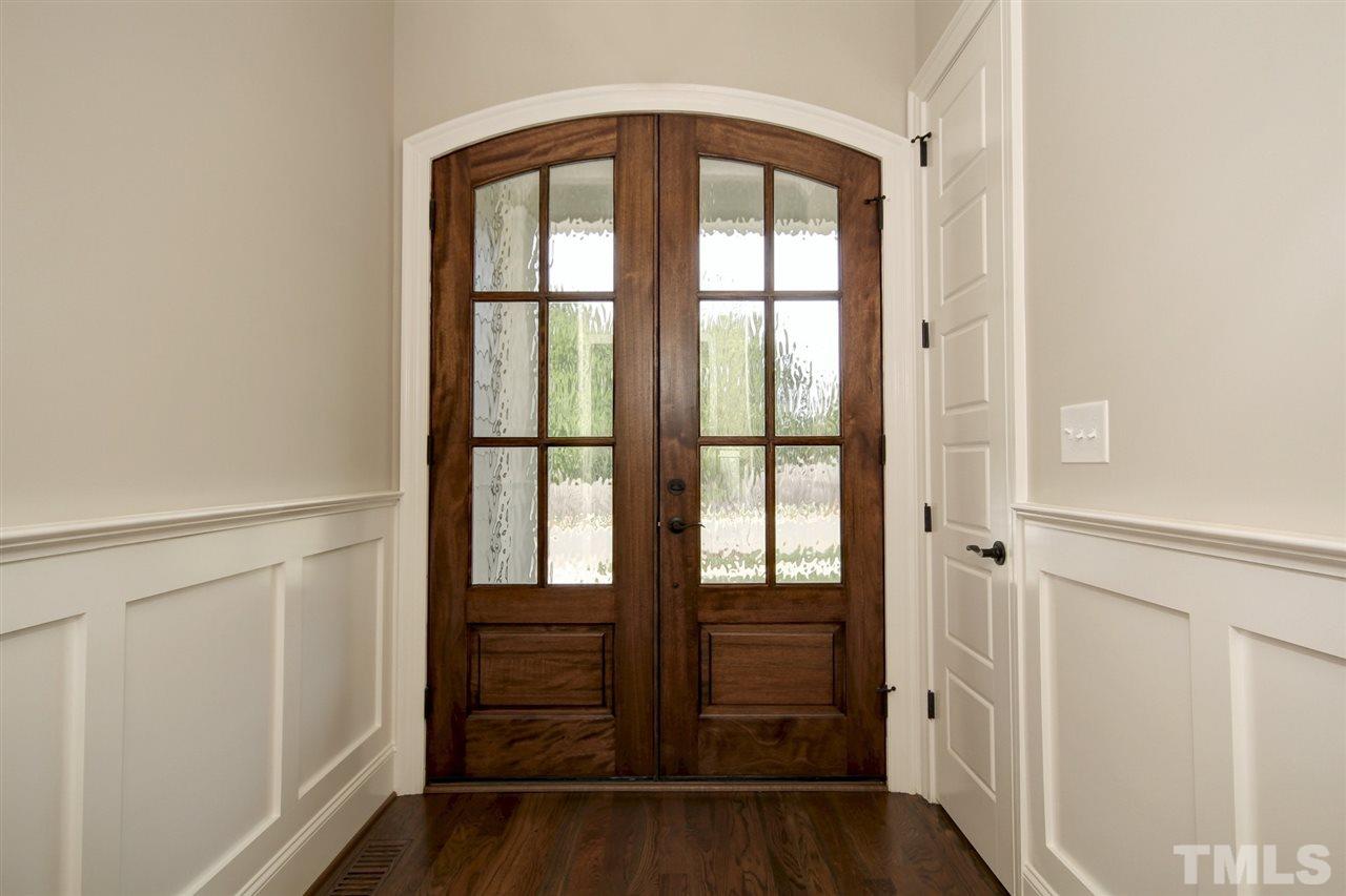 8912 Ashton Garden Way Raleigh, NC 27613 - Photo 22 of 30 a view of front door with wooden floor