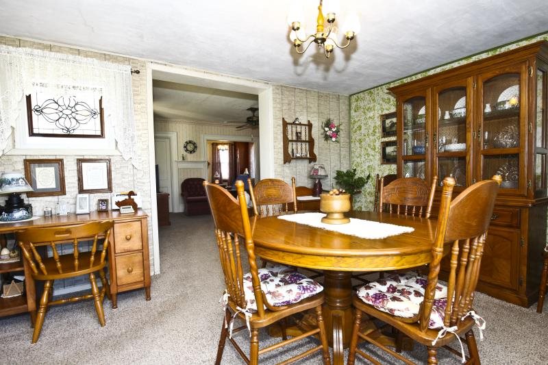 3968 Hunter Road Poplar Grove, IL 61065 - Photo 13 of 25 a dining room with furniture a rug and a chandelier