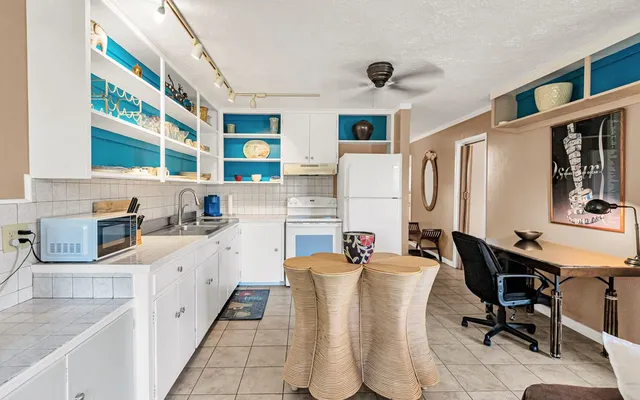 a kitchen with stainless steel appliances kitchen island granite countertop a sink and cabinets