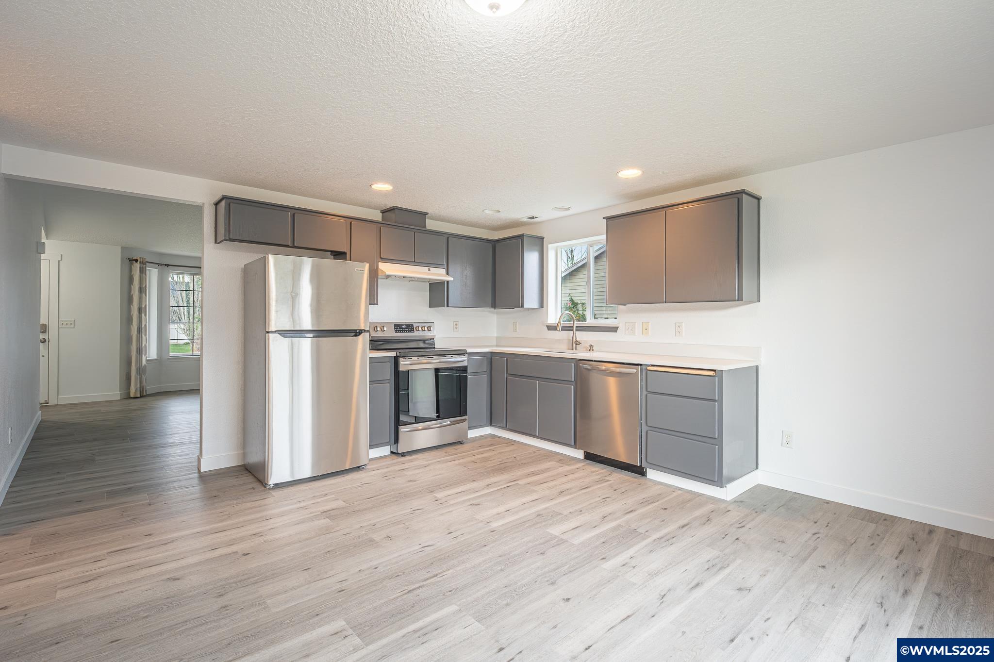 1467 South 7th Street Independence, OR 97351 - Photo 7 of 31 a kitchen with refrigerator cabinets and wooden floor