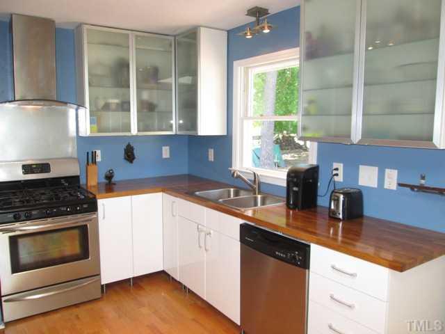 3409 Astro Court Raleigh, NC 27604 - Photo 12 of 25 The kitchen features new cabinets by a well known company and new butcher block counter tops, hardwood floors, slow closing drawers, stainless steel appliances, great skylight for added natural light! Butcher block table does not convey.