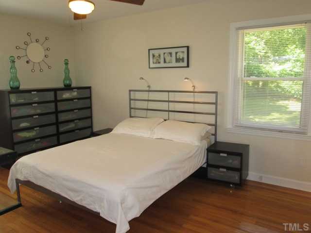 3409 Astro Court Raleigh, NC 27604 - Photo 16 of 25 Great master bedroom features hardwood flooring, ceiling fan with light fixture, and a cedar lined closet! All new interior doors are featured in this home as well!