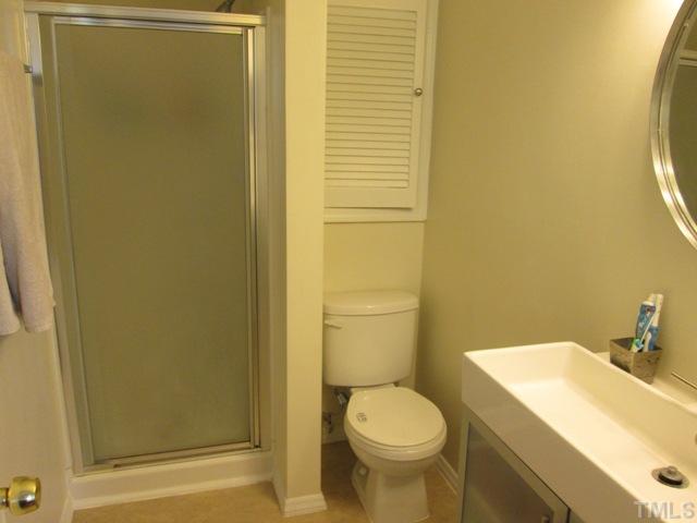 3409 Astro Court Raleigh, NC 27604 - Photo 17 of 25 Your master bathroom features new vinyl flooring, new shower, new toilet, new light, medicine cabinet, laundry shoot to lower level too! Custom sink and vanity are featured as well!