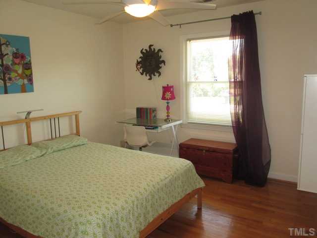 3409 Astro Court Raleigh, NC 27604 - Photo 19 of 25 Nice sized bedrooms! Hardwoods floors! Smooth Ceilings! Ceilings Fan With Light kit and remote! Custom Closet organizers stay with acceptable offer! The hanging dresser in this room doesn't convey.