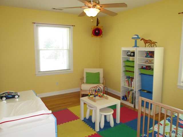 3409 Astro Court Raleigh, NC 27604 - Photo 20 of 25 Bedroom three with hardwoods floors and updated ceiling fan with light kit! Two nice windows let lots of natural light into this room!