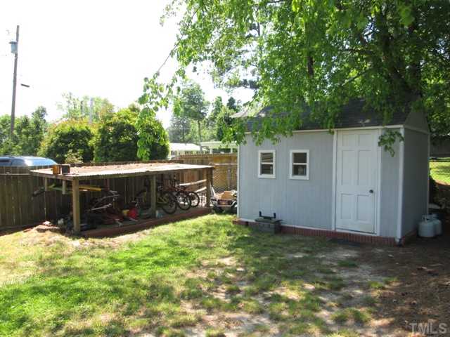 3409 Astro Court Raleigh, NC 27604 - Photo 6 of 25 Lean too, great for storage or as you can see here, bikes and toys! Make a chicken pen out of it if you want! Shed/workshop built on site and stays with acceptable offer! This area is behind the drive way!