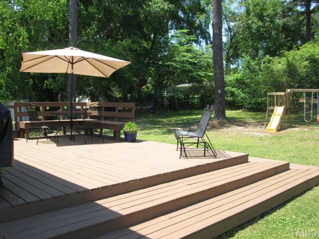3409 Astro Court Raleigh, NC 27604 - Photo 7 of 25 NEW Deck as well only a couple years old! Custom built in bench seating as well as step downs built all the way around! This is also a natural gas line under the deck if you would like to hook up your gas grill!
