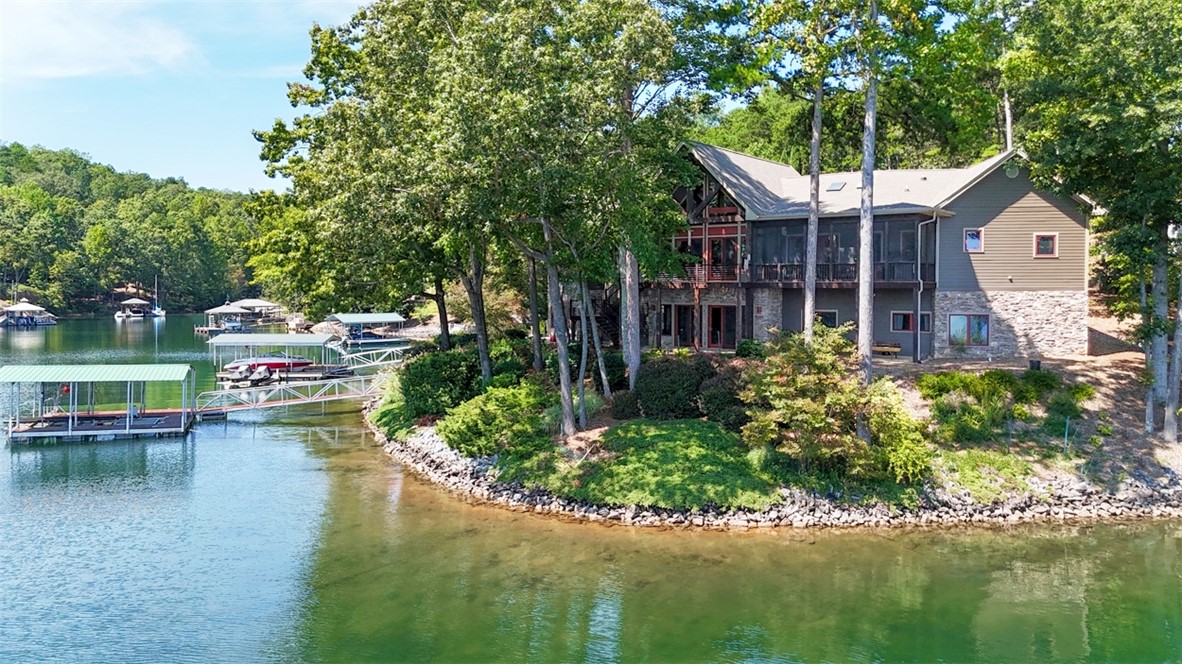 This lakefront home offers a tranquil escape with direct water access and lush surroundings.