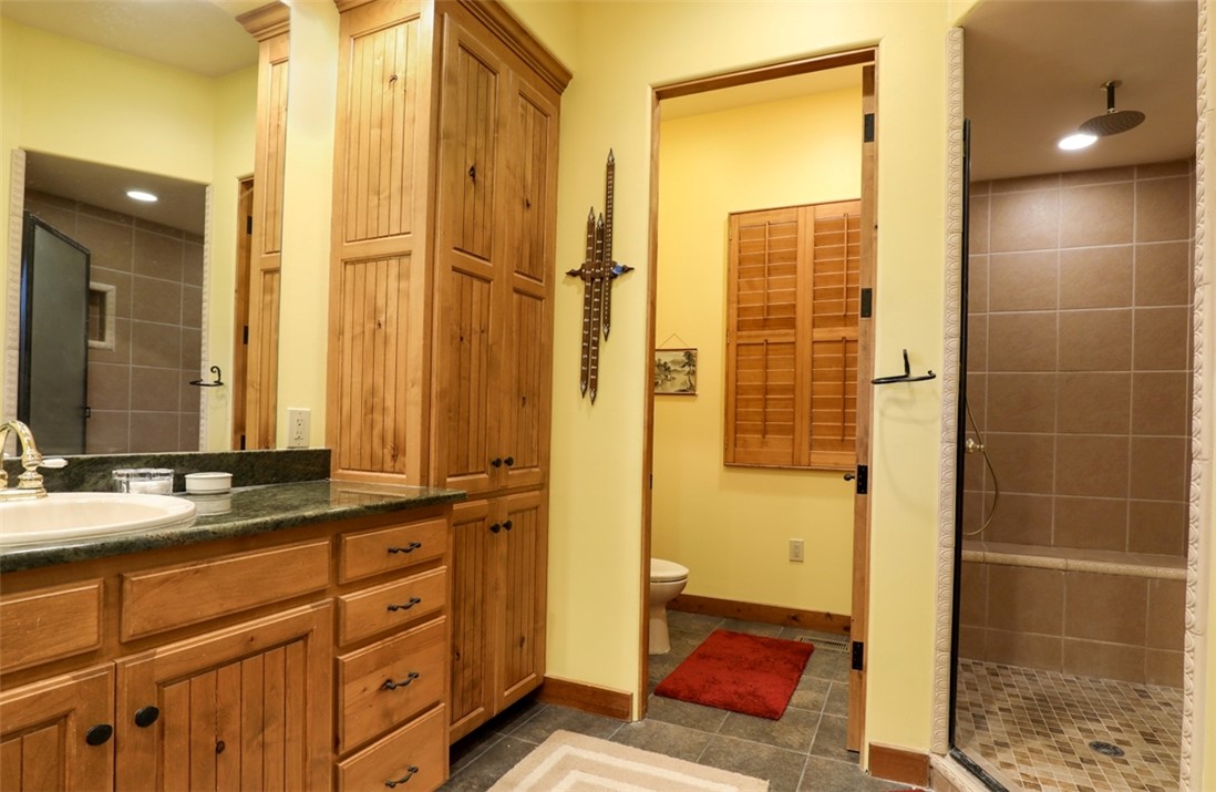 3 Horizon Pointe Lane Salem, SC 29676 - Photo 9 of 30 This bathroom features a spacious shower, rich wooden cabinetry, and tile flooring.