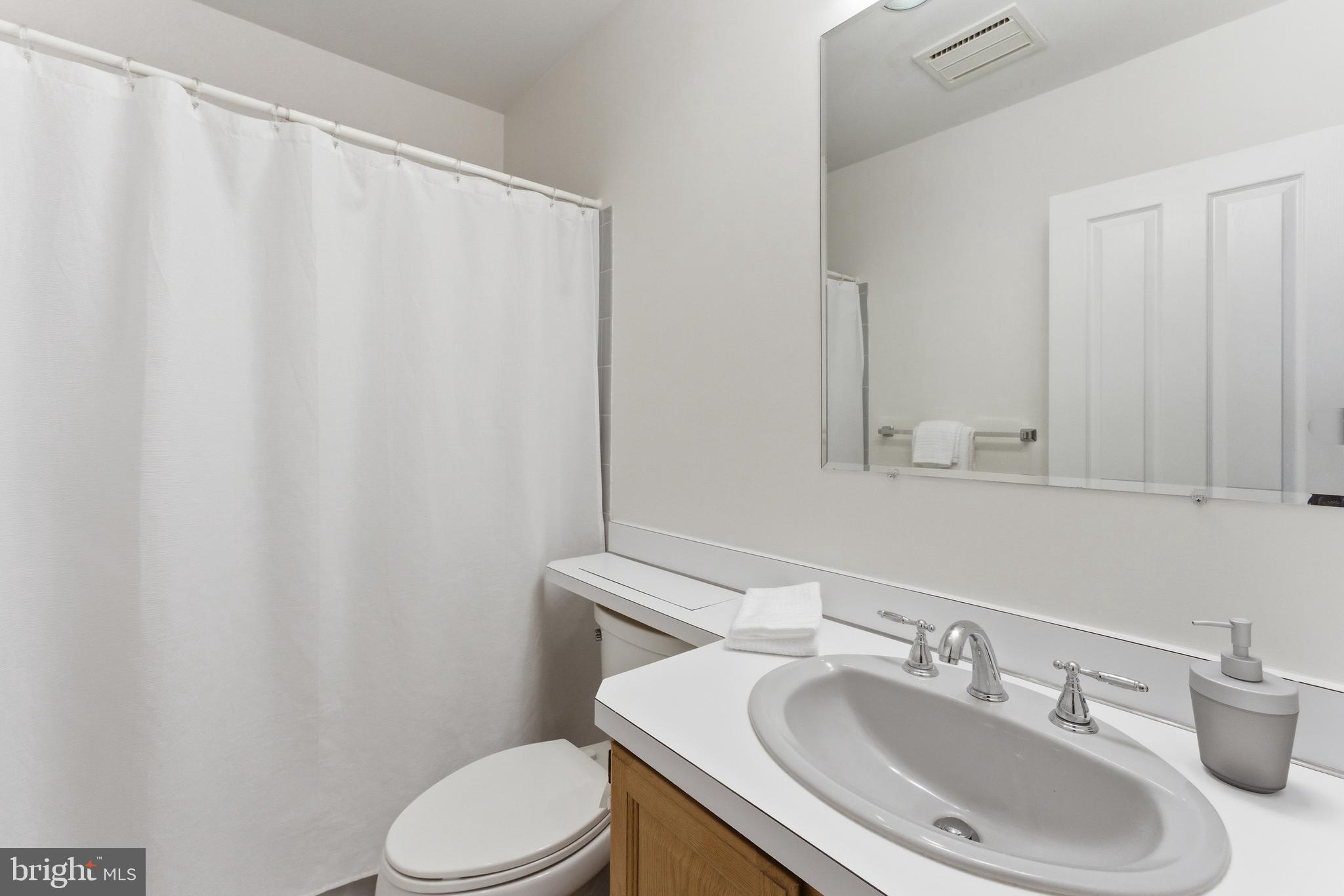 2100 Edgewater Parkway Silver Spring, MD 20903 - Photo 28 of 46 a bathroom with a sink toilet and mirror