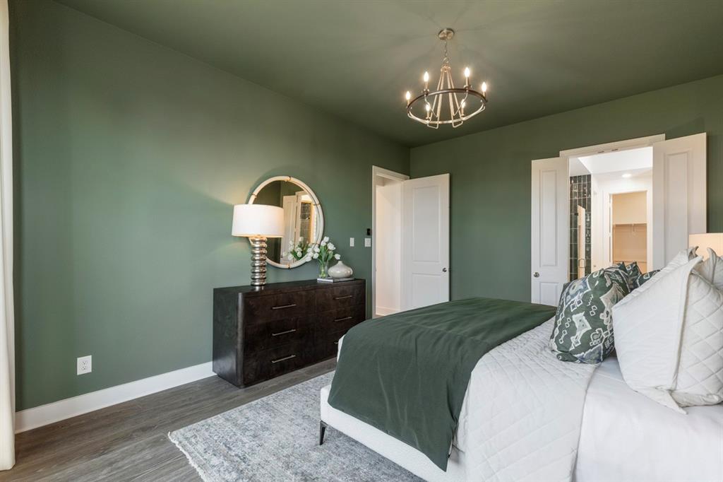 11505 Hardwick Road Haslet, TX 76052 - Photo 15 of 39 a bedroom with a bed and a chandelier