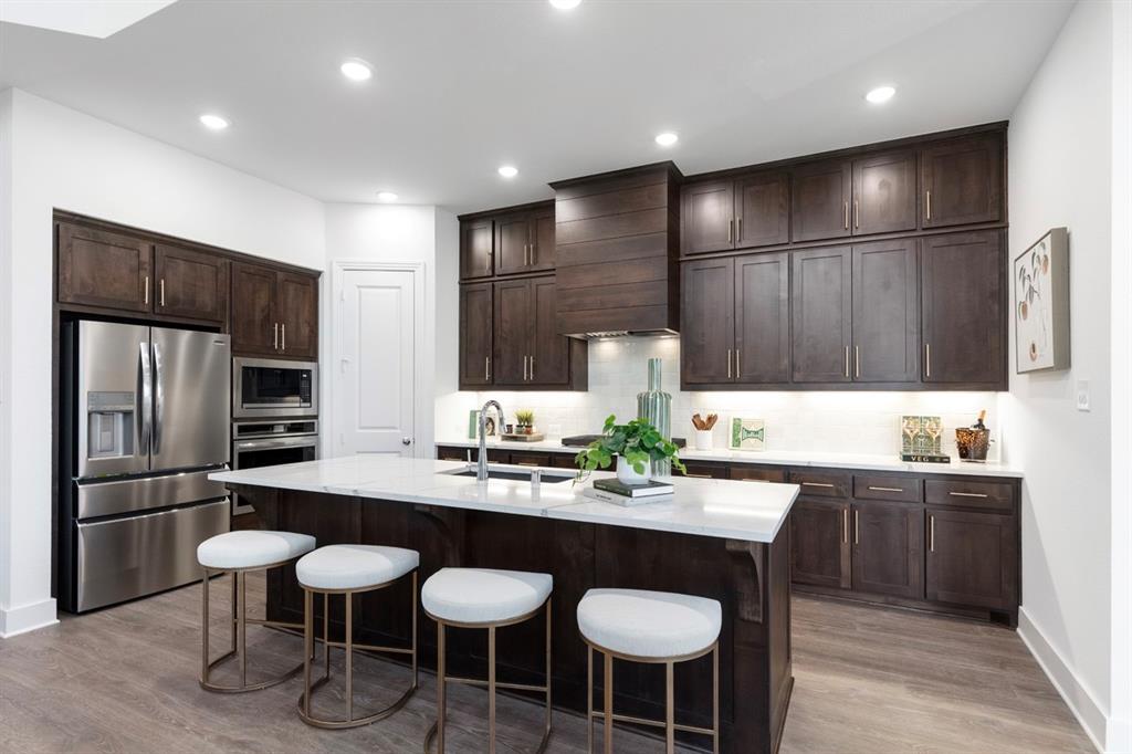 11505 Hardwick Road Haslet, TX 76052 - Photo 2 of 39 a kitchen with granite countertop a sink and stainless steel appliances