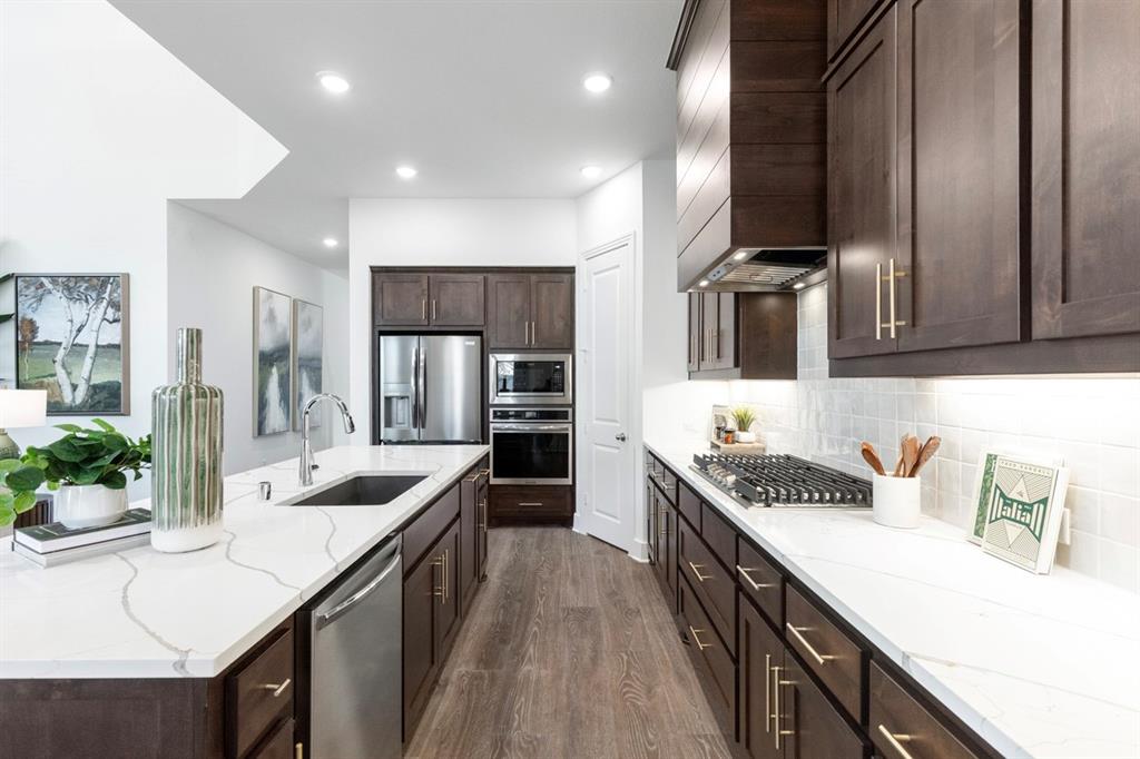 11505 Hardwick Road Haslet, TX 76052 - Photo 6 of 39 a kitchen with stainless steel appliances a sink stove and cabinets