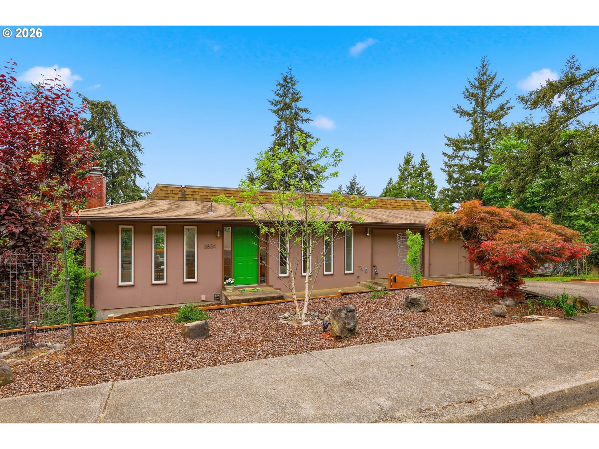 3834 Onyx Street Eugene, OR 97405 - Photo 1 of 43 a front view of a house with a garden