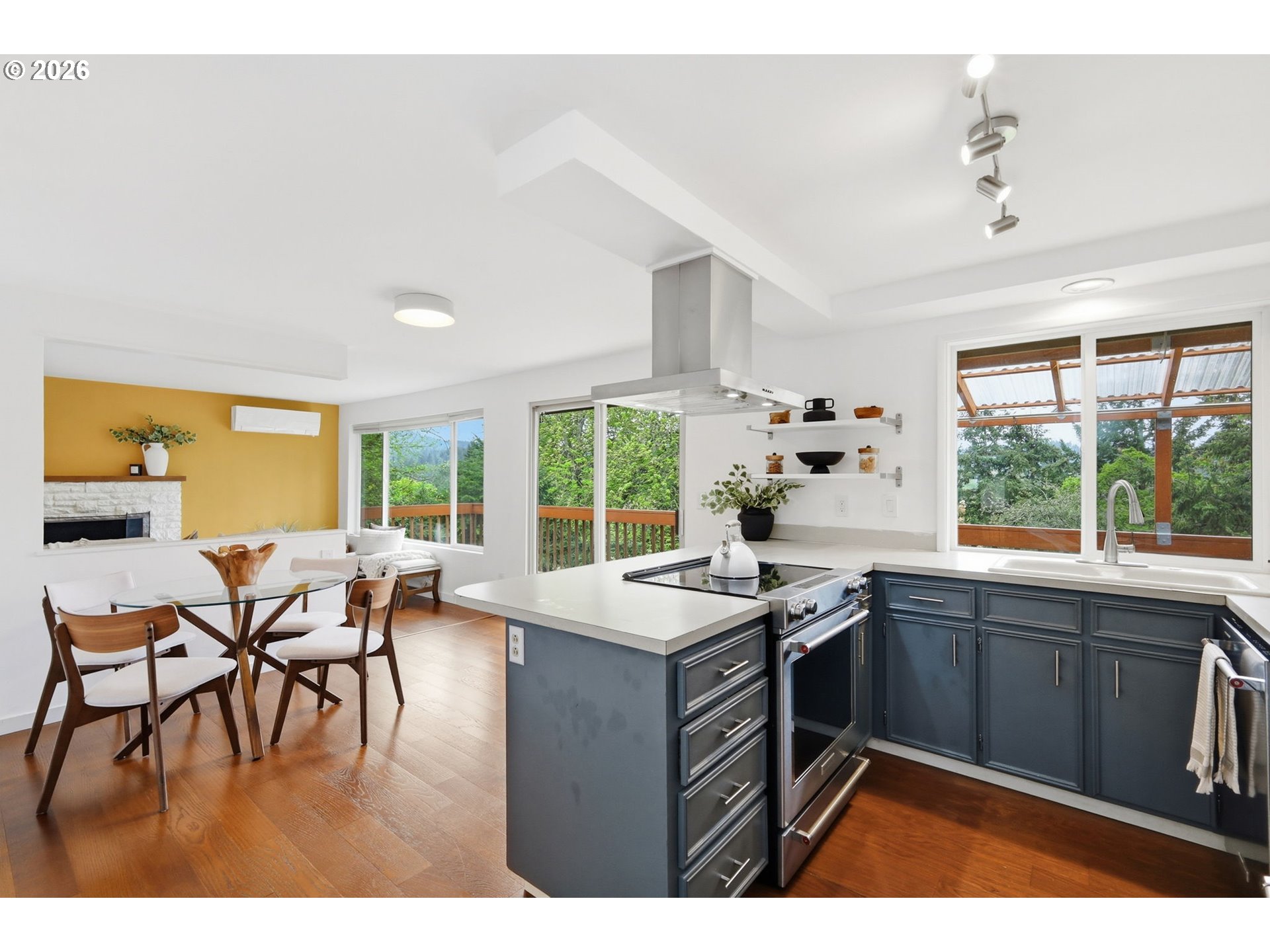3834 Onyx Street Eugene, OR 97405 - Photo 20 of 43 a kitchen with a stove a sink a dining table and chairs