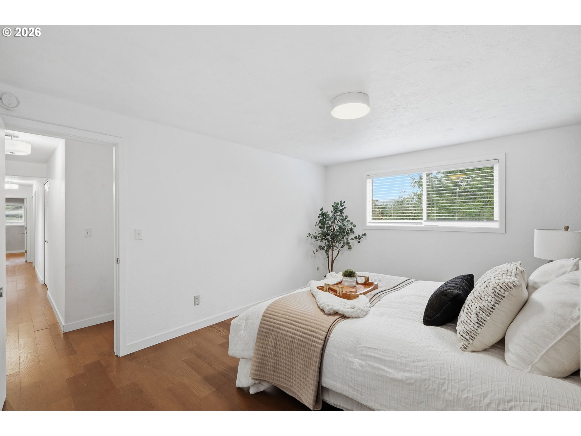 3834 Onyx Street Eugene, OR 97405 - Photo 26 of 43 a bedroom with a bed and a potted plant