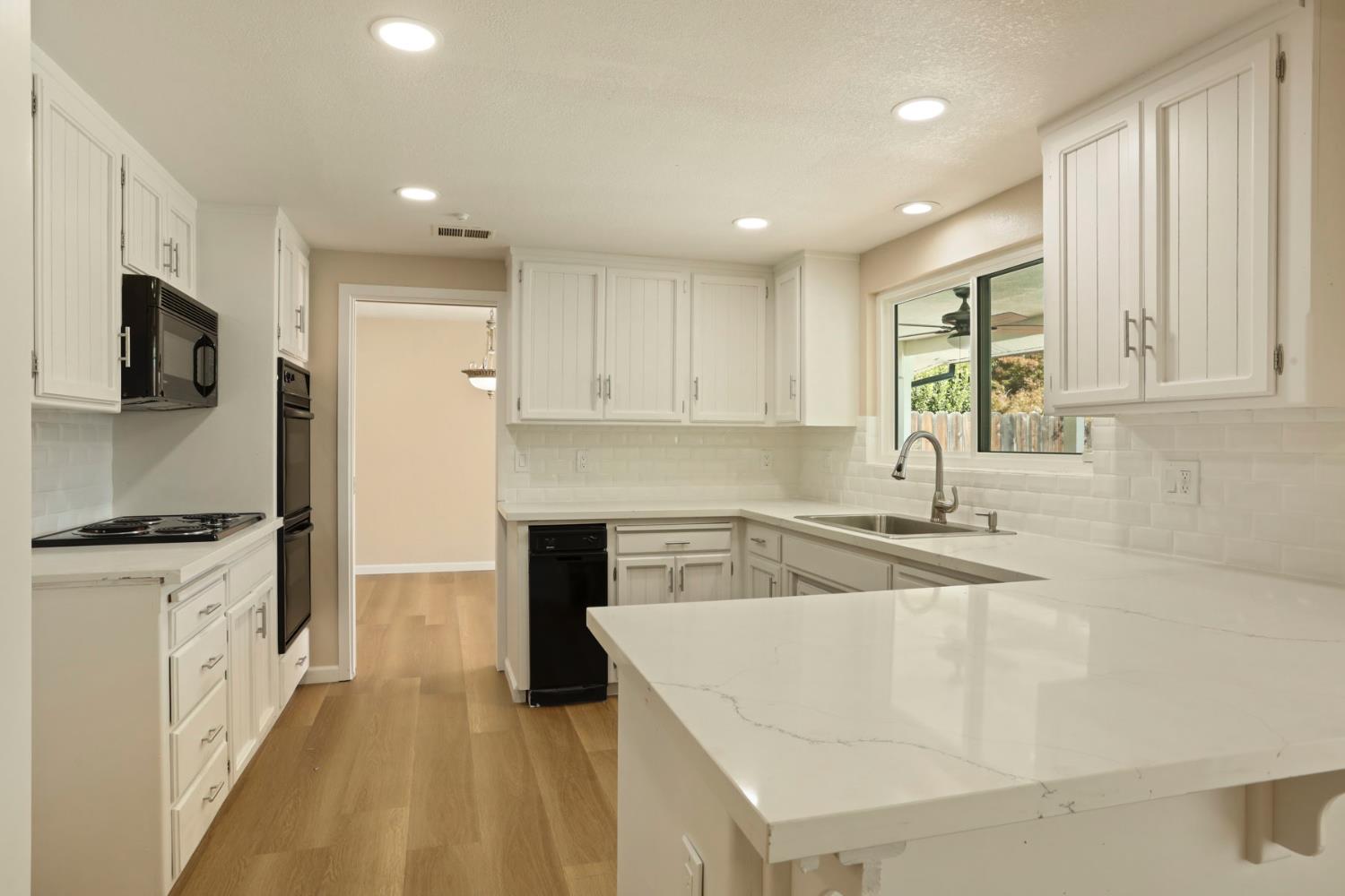 3524 Marsala Way Modesto, CA 95356 - Photo 11 of 40 a kitchen with granite countertop a sink stove and refrigerator