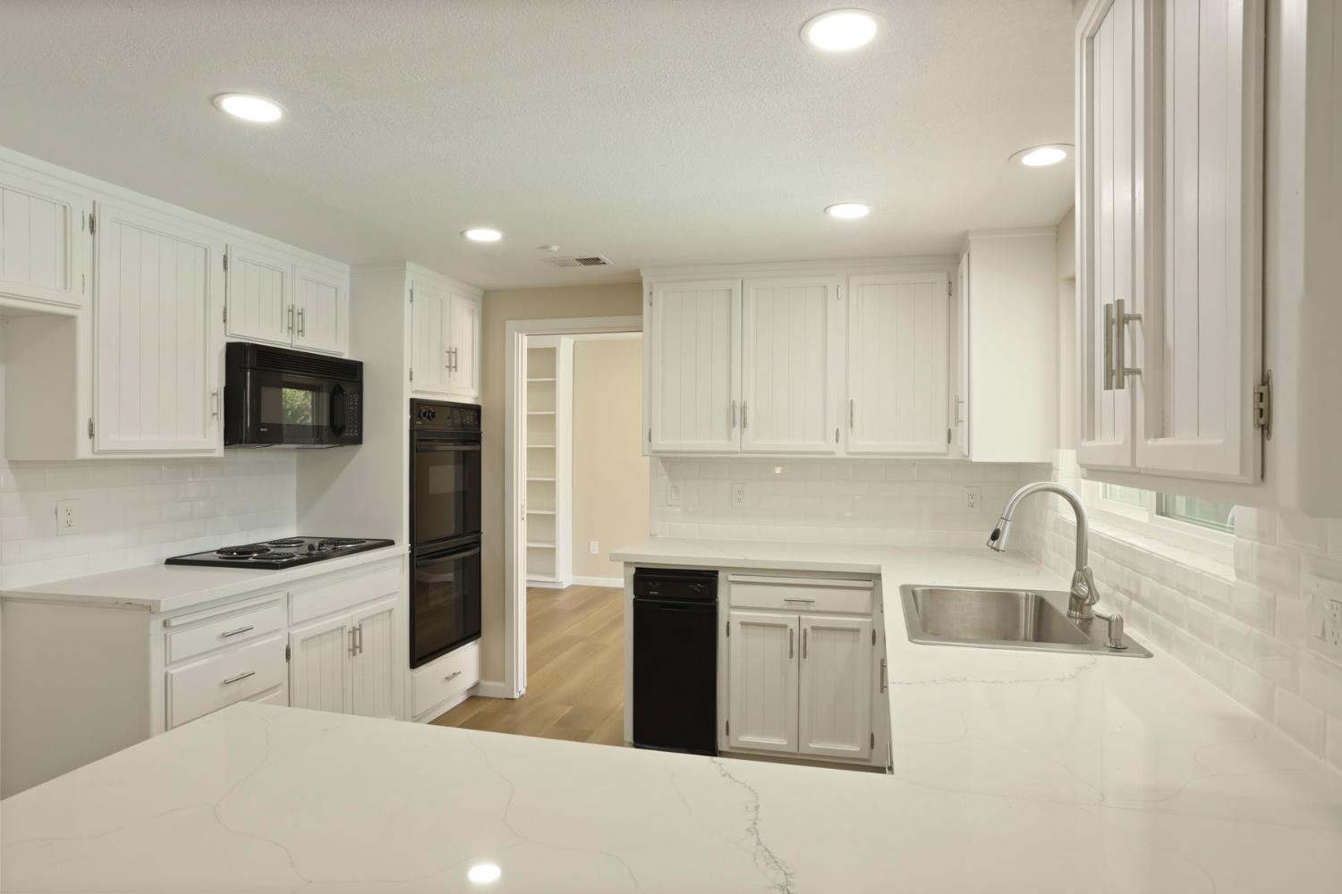 3524 Marsala Way Modesto, CA 95356 - Photo 12 of 40 a kitchen with stainless steel appliances granite countertop a sink a stove and a refrigerator