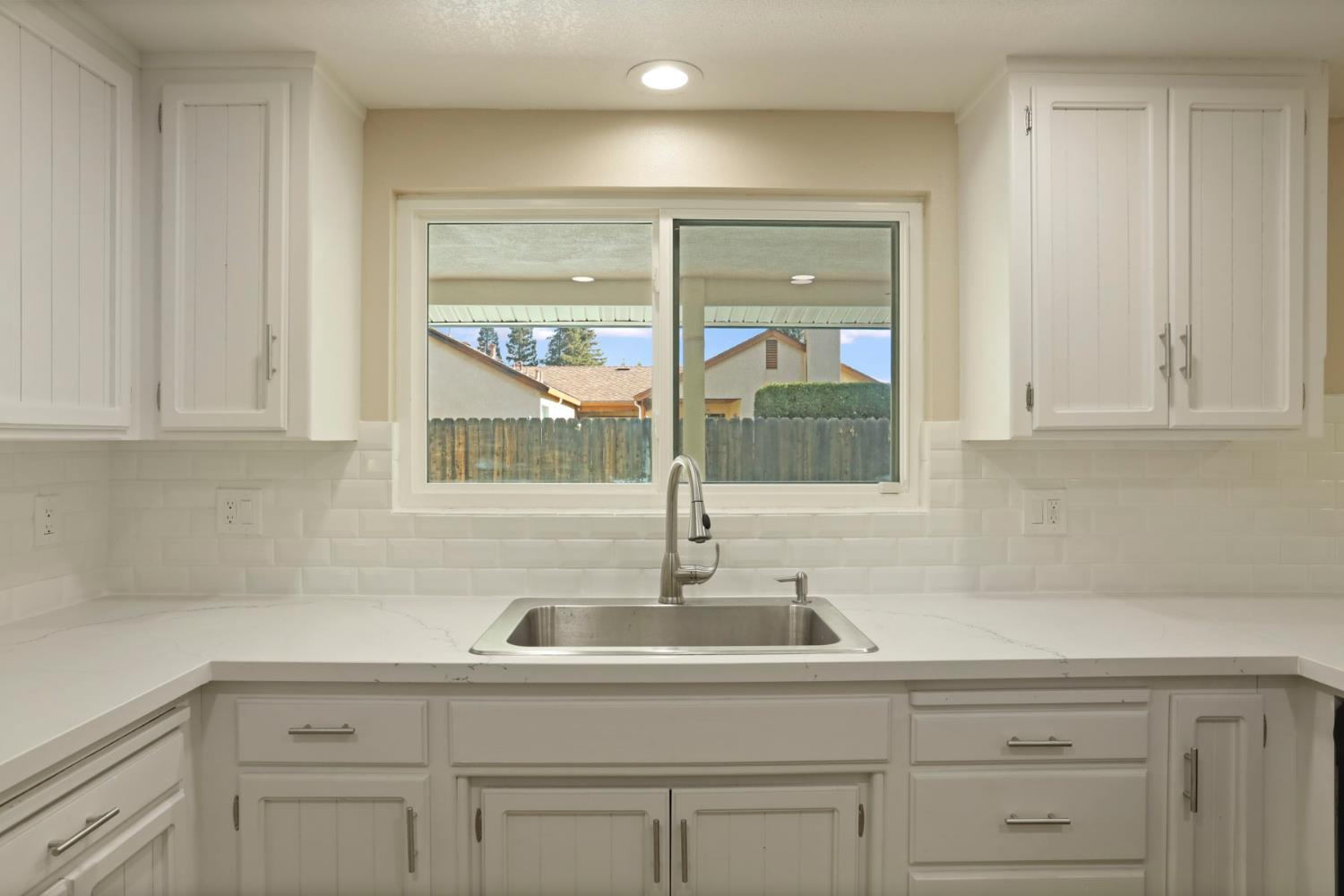 3524 Marsala Way Modesto, CA 95356 - Photo 13 of 40 a kitchen with white cabinets and a sink