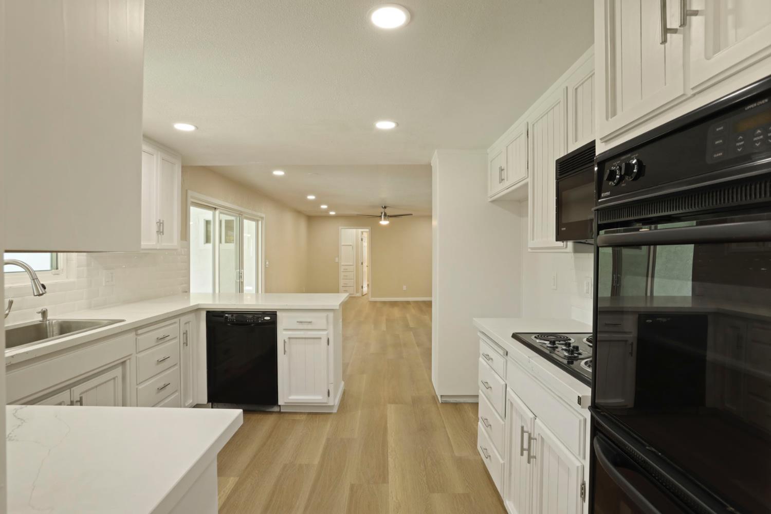 3524 Marsala Way Modesto, CA 95356 - Photo 14 of 40 a kitchen with stainless steel appliances granite countertop a sink a stove and a refrigerator