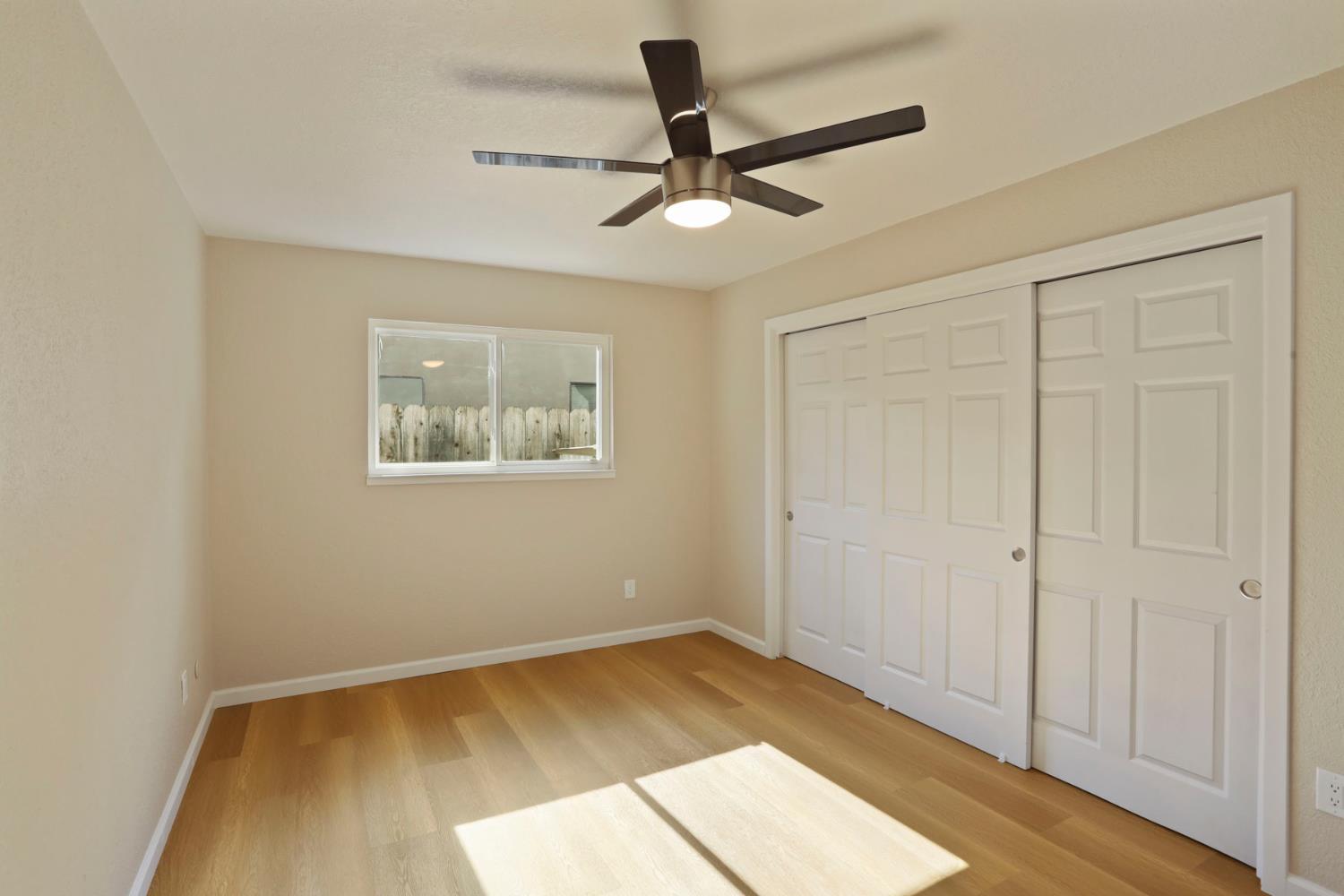 3524 Marsala Way Modesto, CA 95356 - Photo 26 of 40 a view of empty room with wooden floor and fan