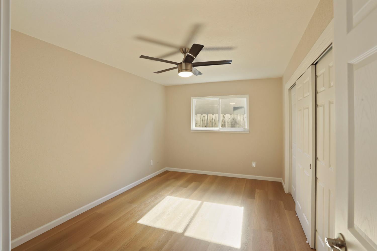3524 Marsala Way Modesto, CA 95356 - Photo 27 of 40 an empty room with a window and a ceiling fan