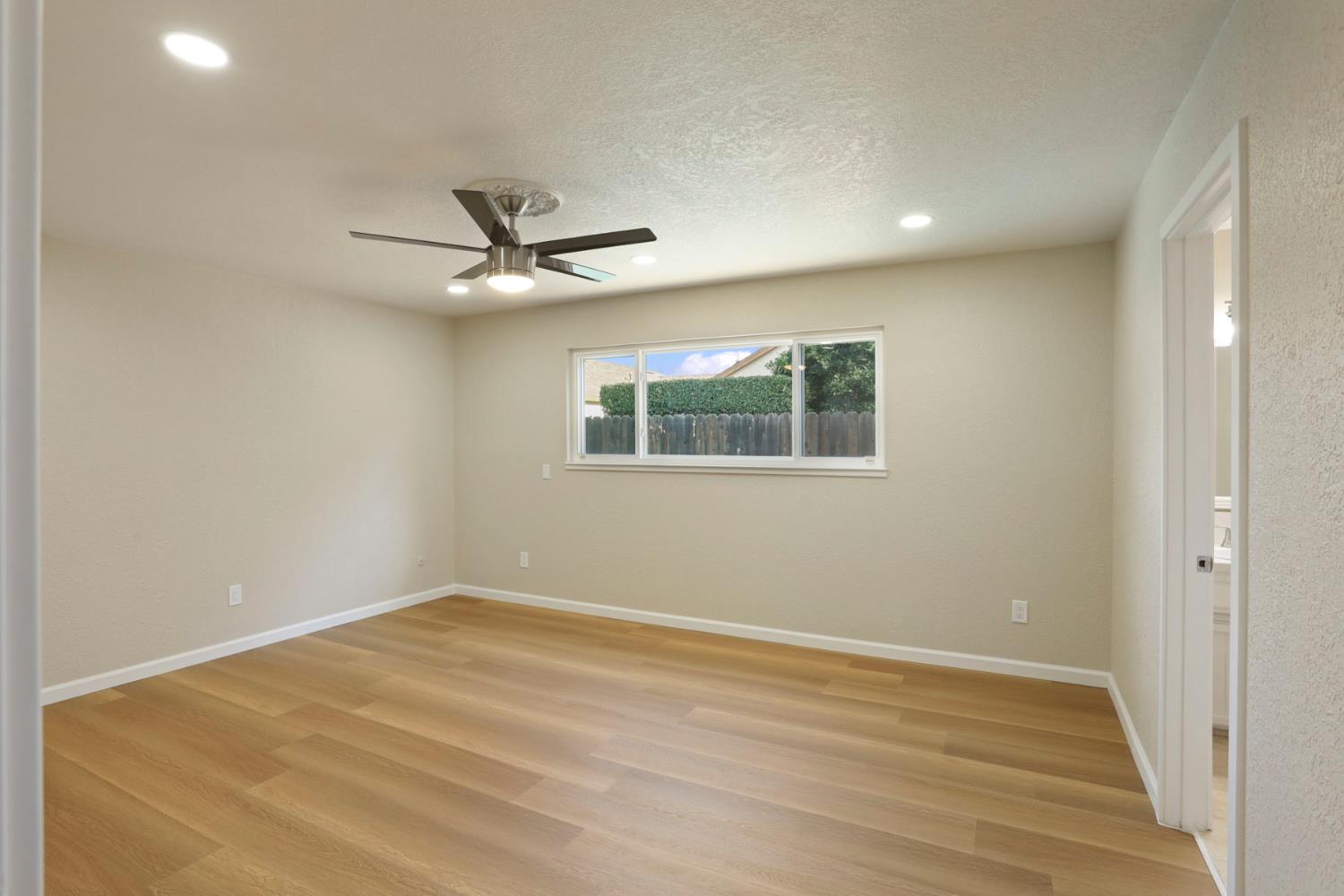 3524 Marsala Way Modesto, CA 95356 - Photo 30 of 40 an empty room with wooden floor and ceiling fan