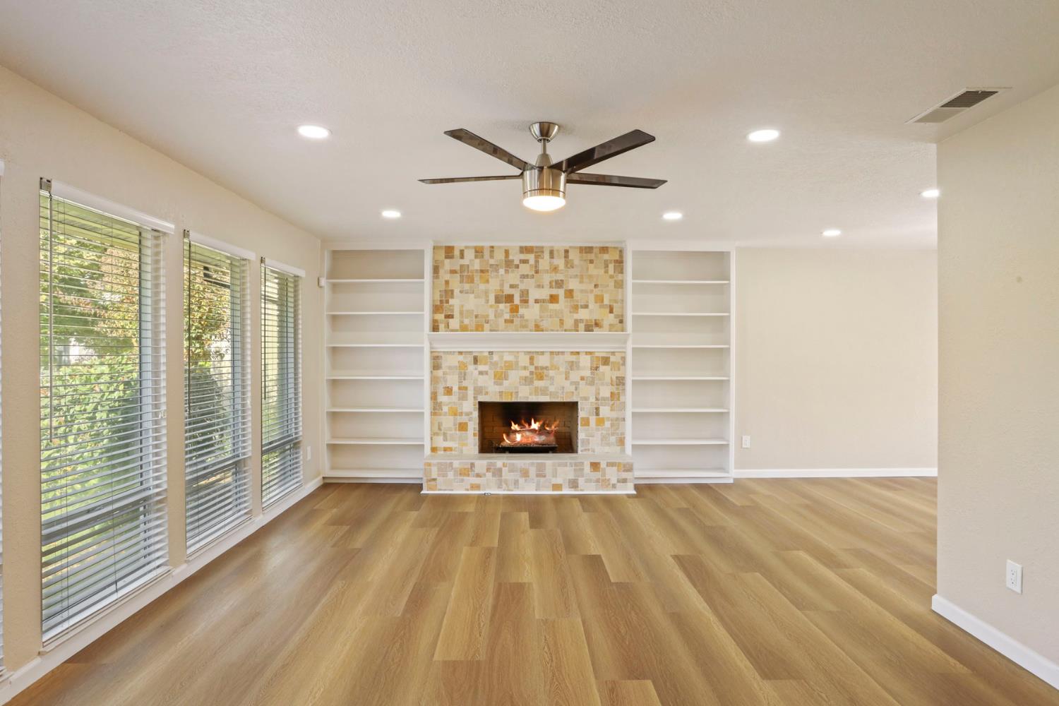 3524 Marsala Way Modesto, CA 95356 - Photo 5 of 40 a view of a livingroom with a fireplace a ceiling fan and window