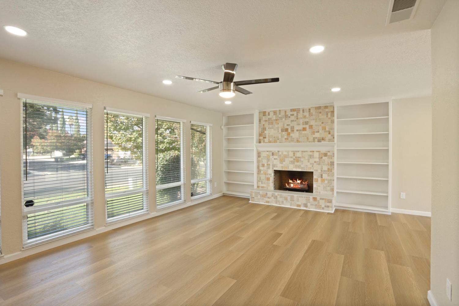 3524 Marsala Way Modesto, CA 95356 - Photo 6 of 40 a view of an empty room with a fireplace and a window