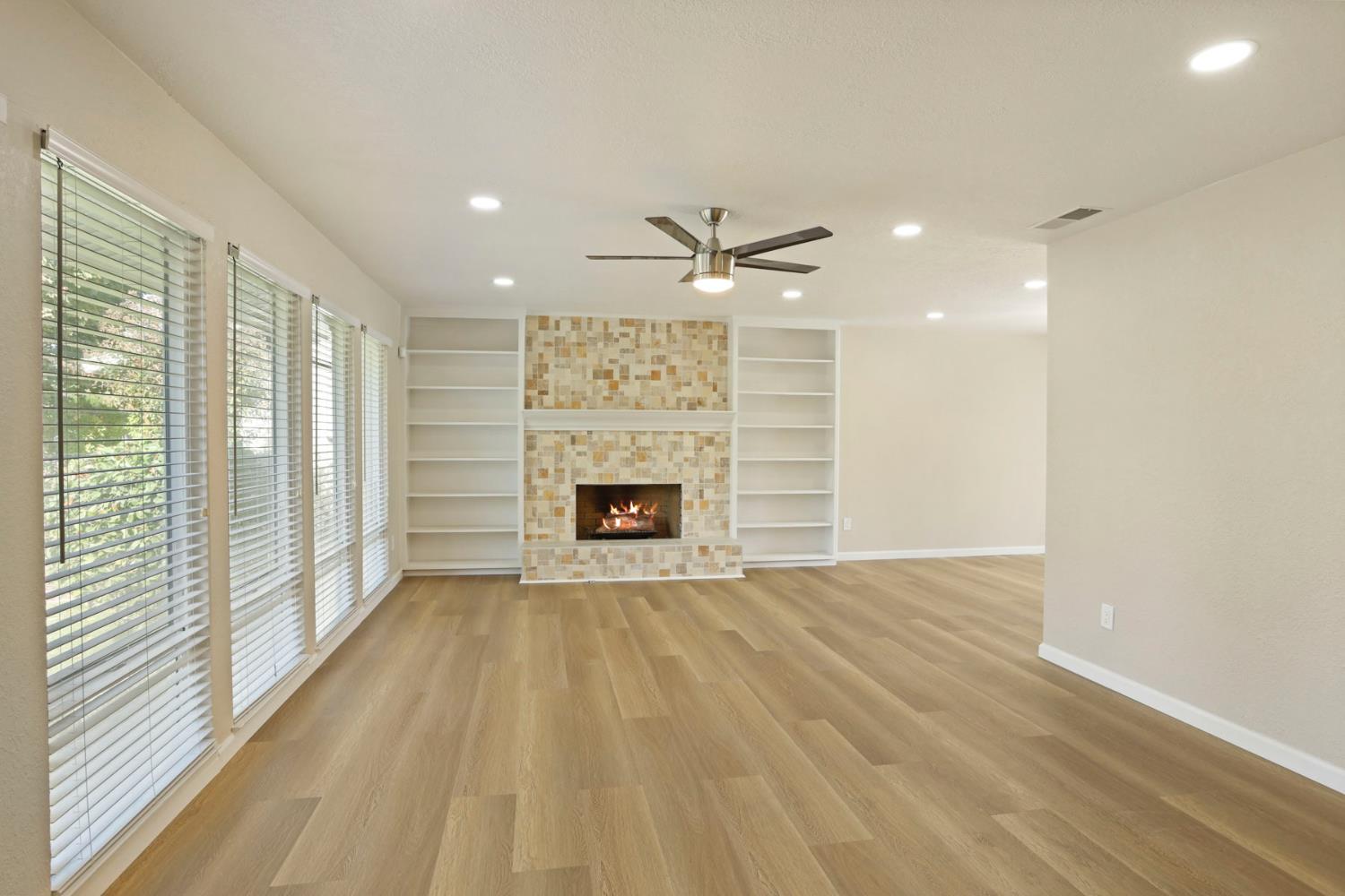 3524 Marsala Way Modesto, CA 95356 - Photo 7 of 40 a view of an empty room with a fireplace and a window