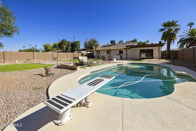 a view of swimming pool with outdoor seating and city view
