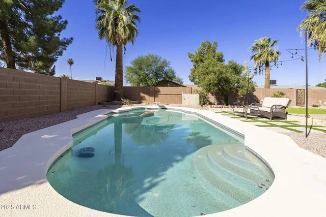 a view of a swimming pool with a lounge chair