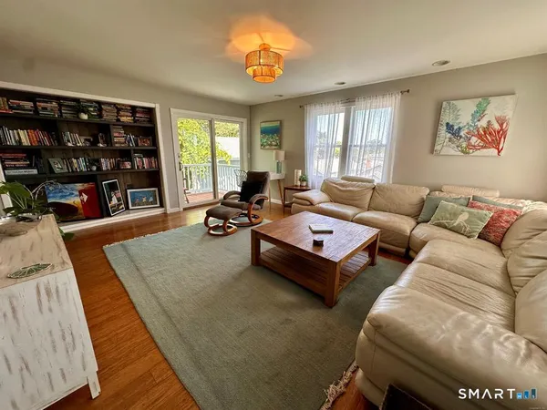 a living room with furniture a window and bookshelf