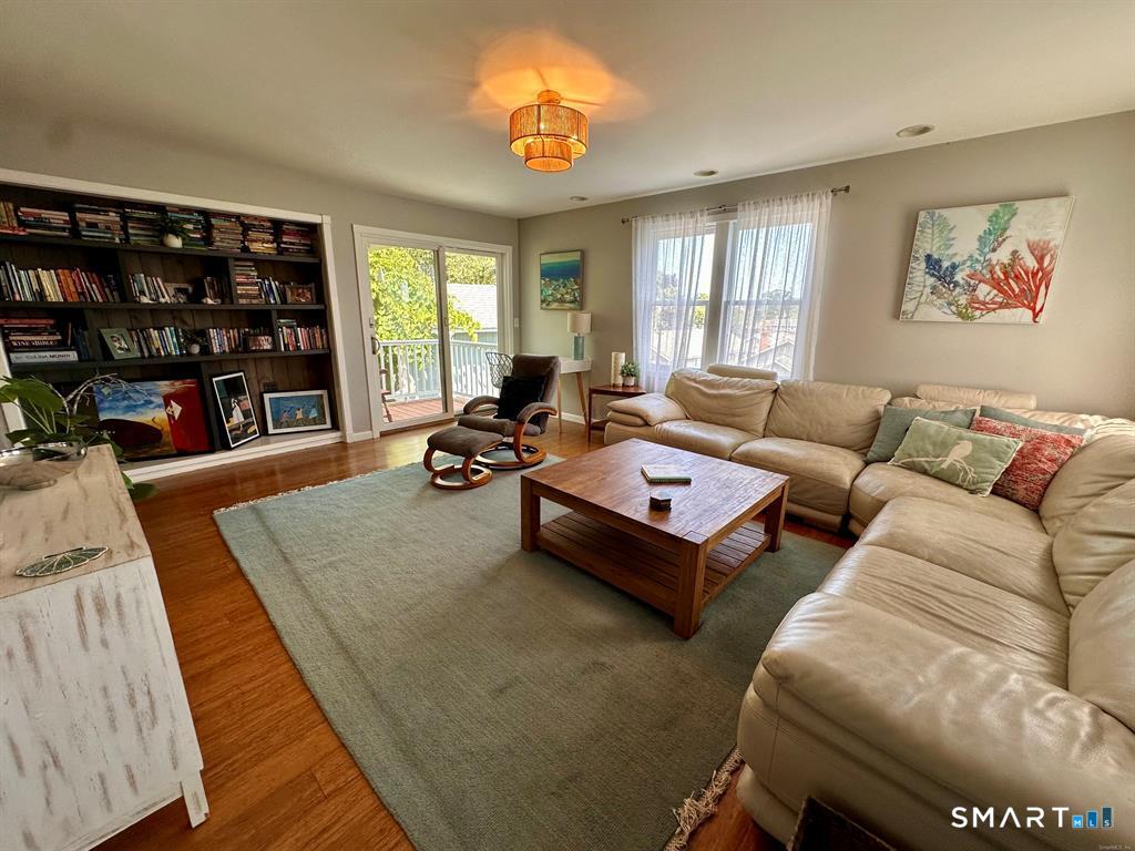 44 Warren Street Milford, CT 06460 - Photo 11 of 29 a living room with furniture a window and bookshelf