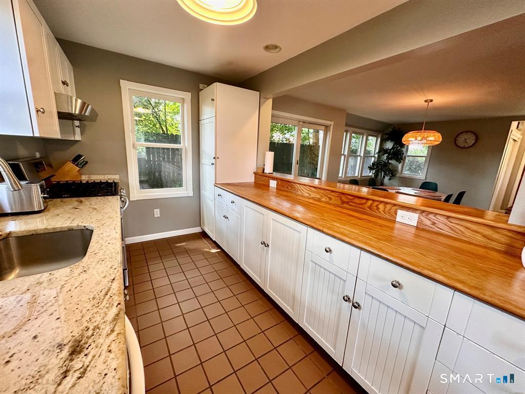 44 Warren Street Milford, CT 06460 - Photo 12 of 29 a large white kitchen with stainless steel appliances granite countertop a sink and cabinets