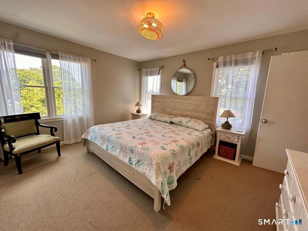 44 Warren Street Milford, CT 06460 - Photo 14 of 29 a bedroom with a bed couch and a window