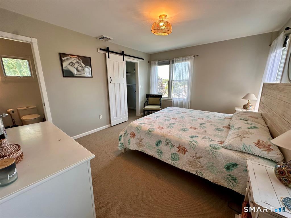 44 Warren Street Milford, CT 06460 - Photo 15 of 29 a bedroom with a bed and a table in it