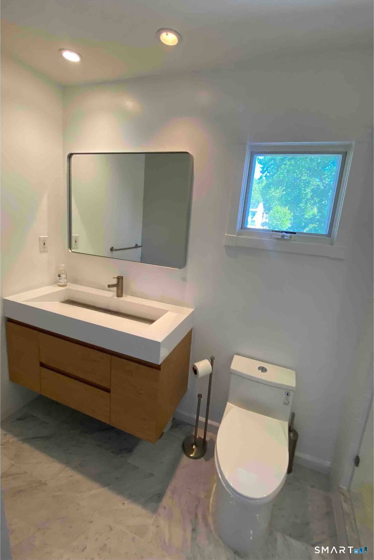 44 Warren Street Milford, CT 06460 - Photo 18 of 29 a bathroom with a toilet sink and mirror