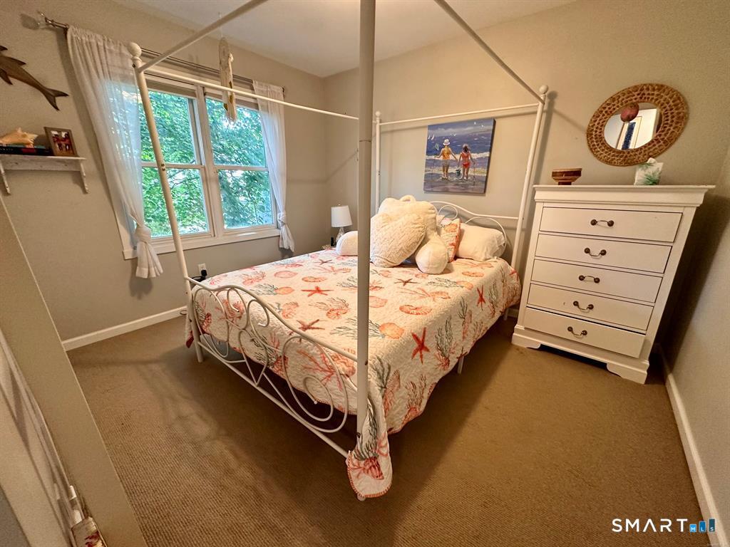 44 Warren Street Milford, CT 06460 - Photo 20 of 29 a bed sitting in a bedroom next to a window