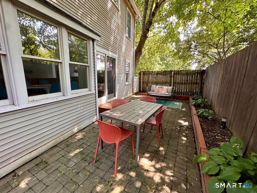 44 Warren Street Milford, CT 06460 - Photo 22 of 29 a backyard of a house with table and chairs