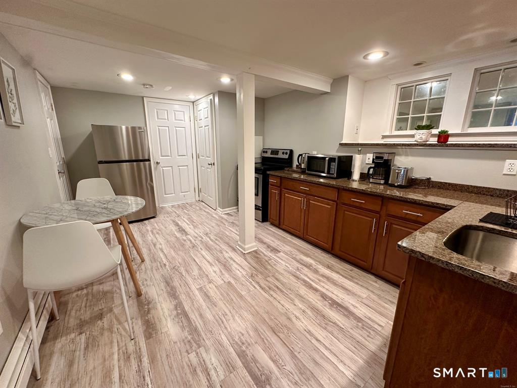 44 Warren Street Milford, CT 06460 - Photo 23 of 29 a kitchen with stainless steel appliances granite countertop a sink refrigerator and cabinets