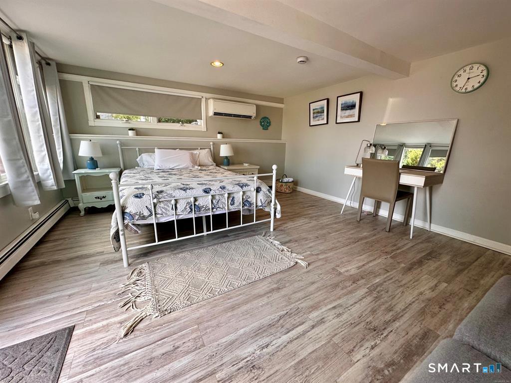 44 Warren Street Milford, CT 06460 - Photo 24 of 29 a bedroom with a bed and wooden floor