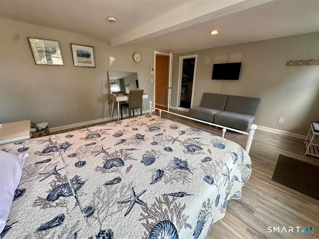 44 Warren Street Milford, CT 06460 - Photo 25 of 29 a bedroom with a bed and a flat screen tv