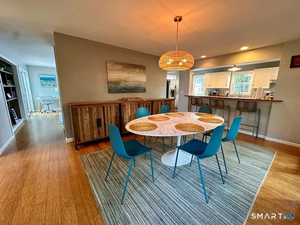 a view of a dining room with furniture window and wooden floor