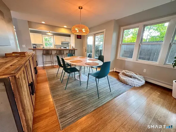 a view of a dining room with furniture and wooden floor