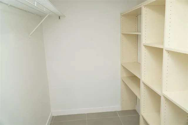 a view of hallway with stairs and a window